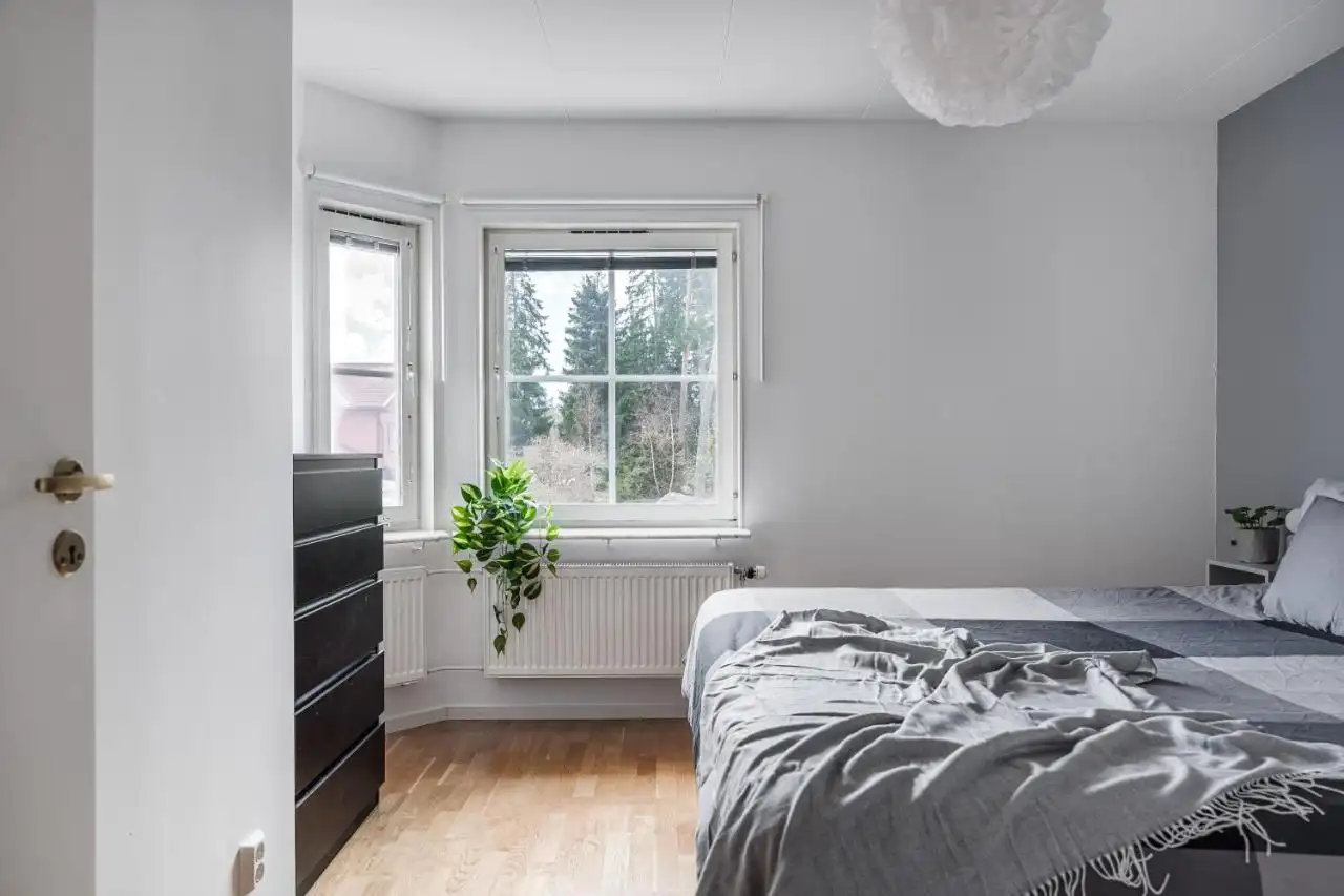 Cozy bedroom with window overlooking forest in Uppsala short term rental