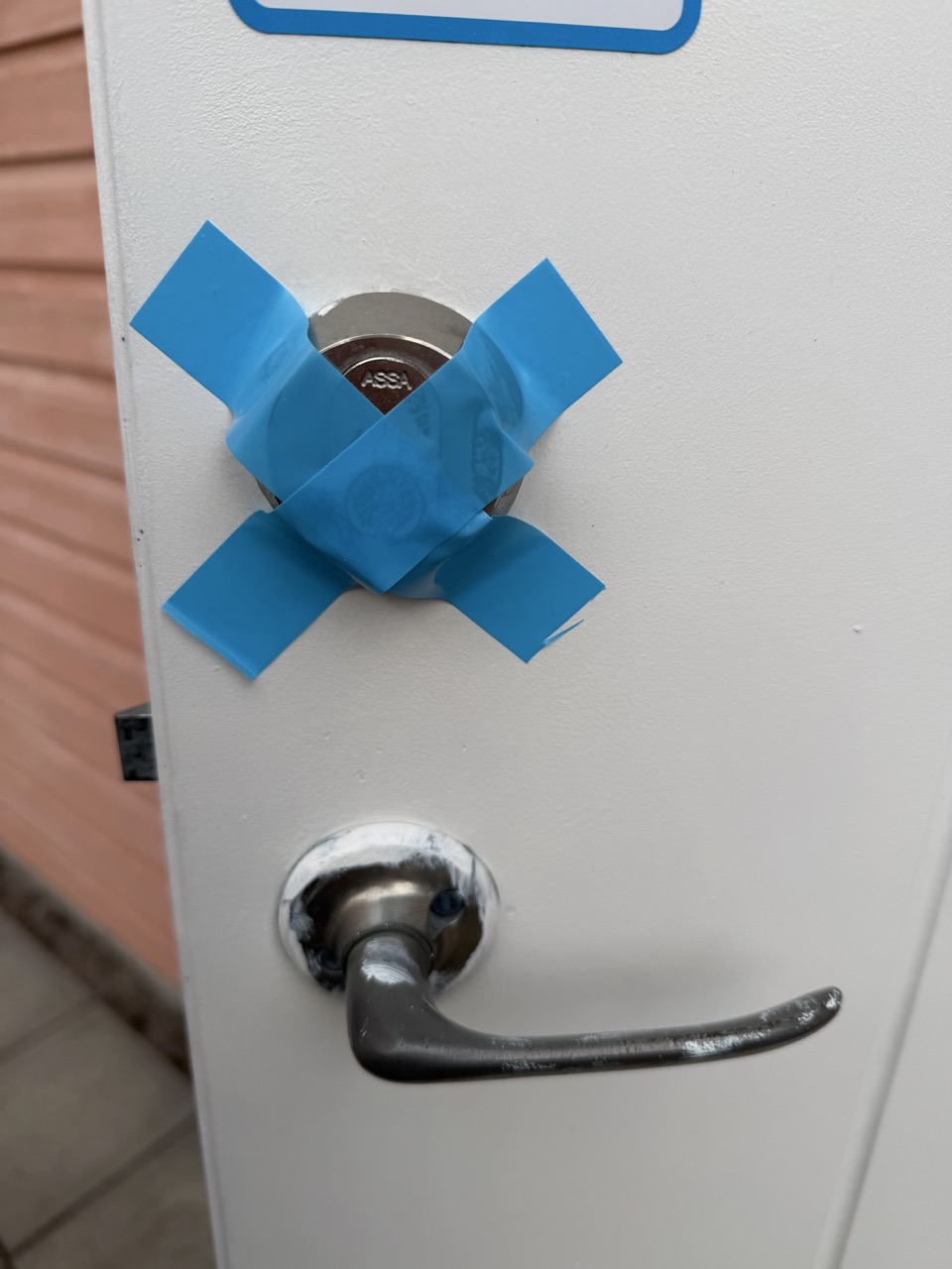 Storage door exterior secured with blue painter's tape during install