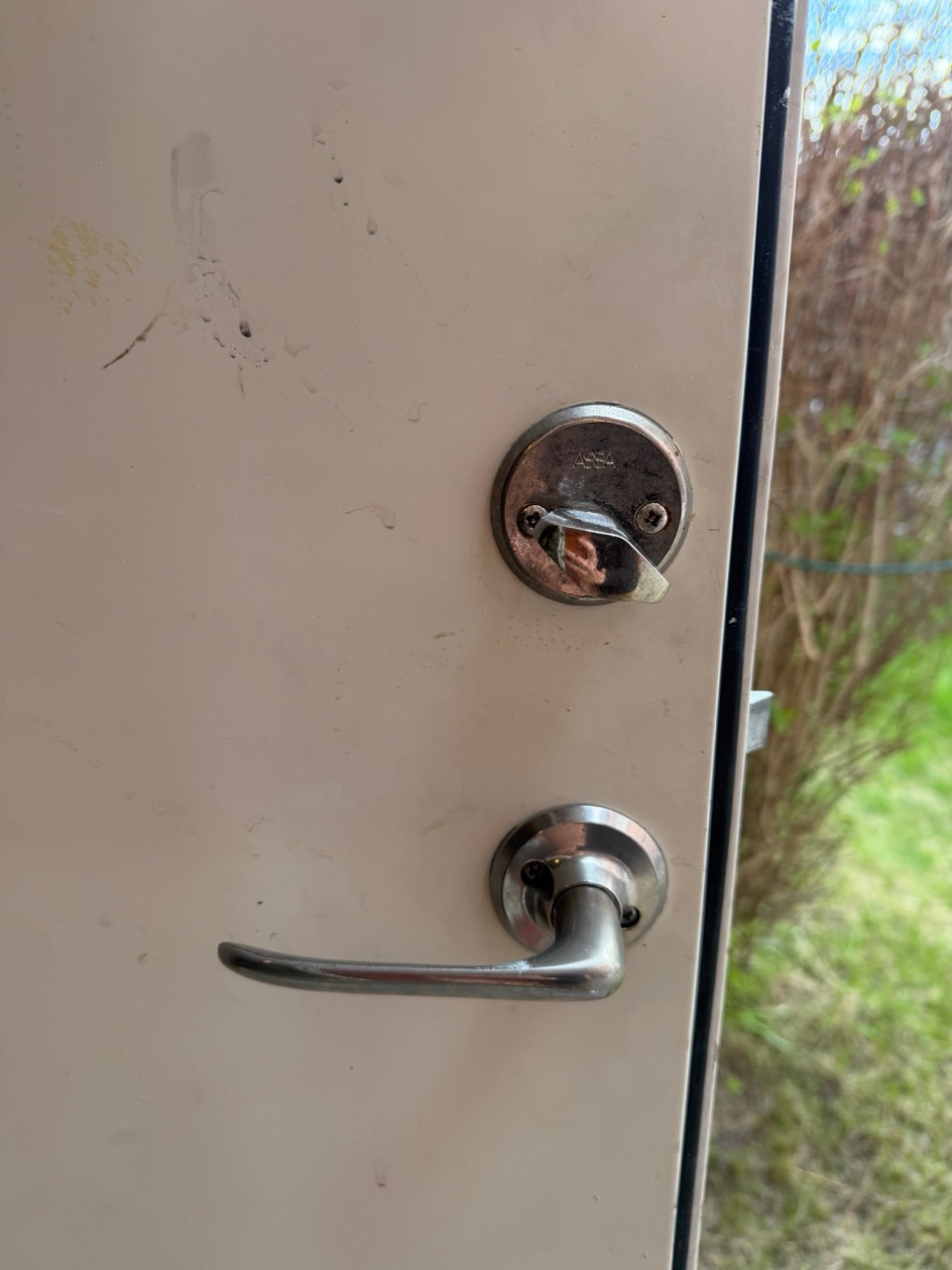 Storage room door exterior — round Assa cylinder before the install