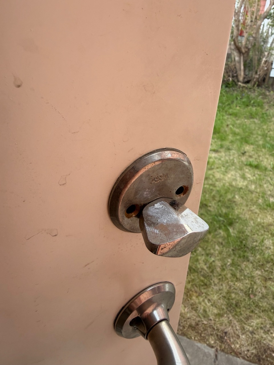 Storage door interior with knob mid-removal
