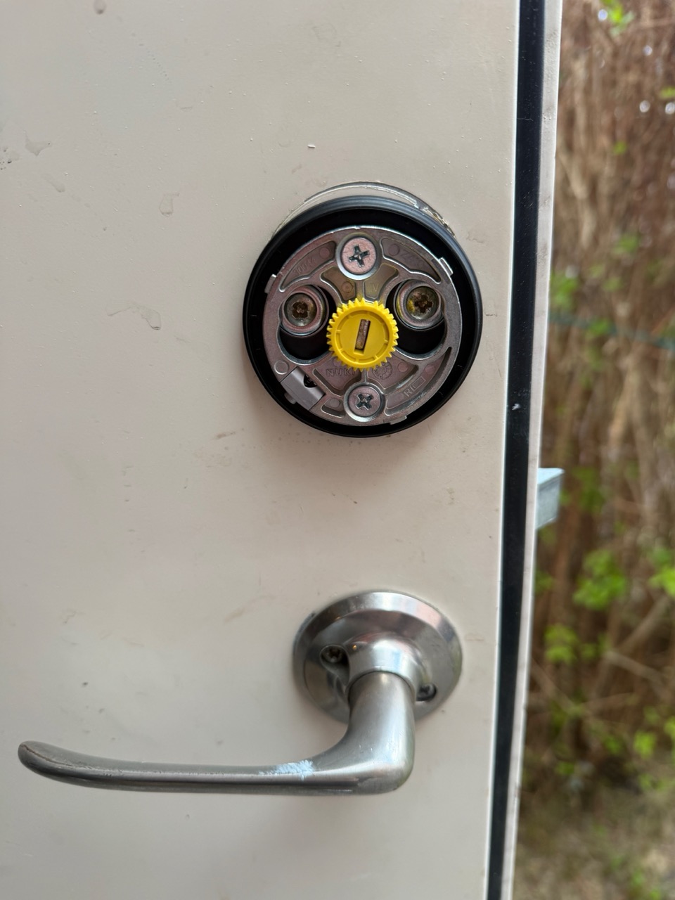 Mounting plate with the yellow adapter centered, ready for the Nuki Smart Lock to attach