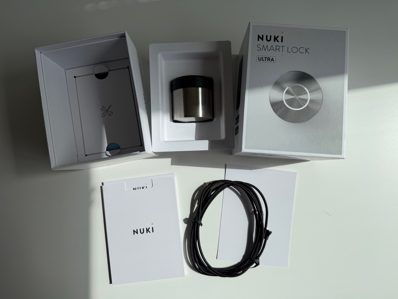Nuki Smart Lock Ultra Nordics unboxed with magnetic USB-C charging cable and manual