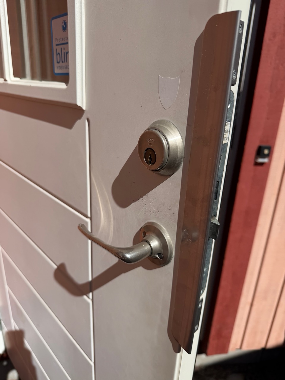 Assa 2000 front door exterior with Blink camera sticker