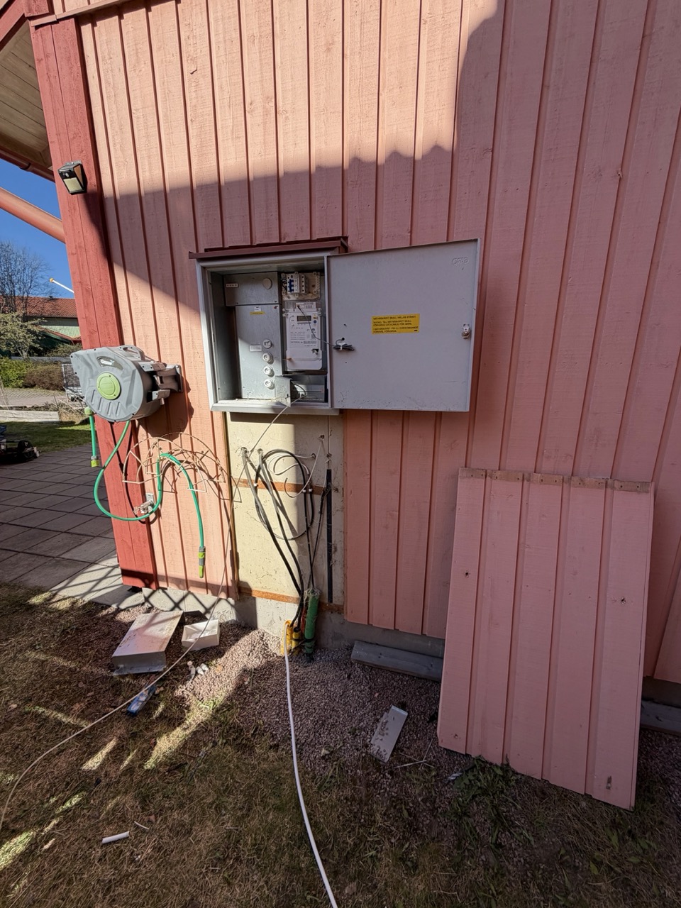 Cables passed down through the exterior wall, fuse box open