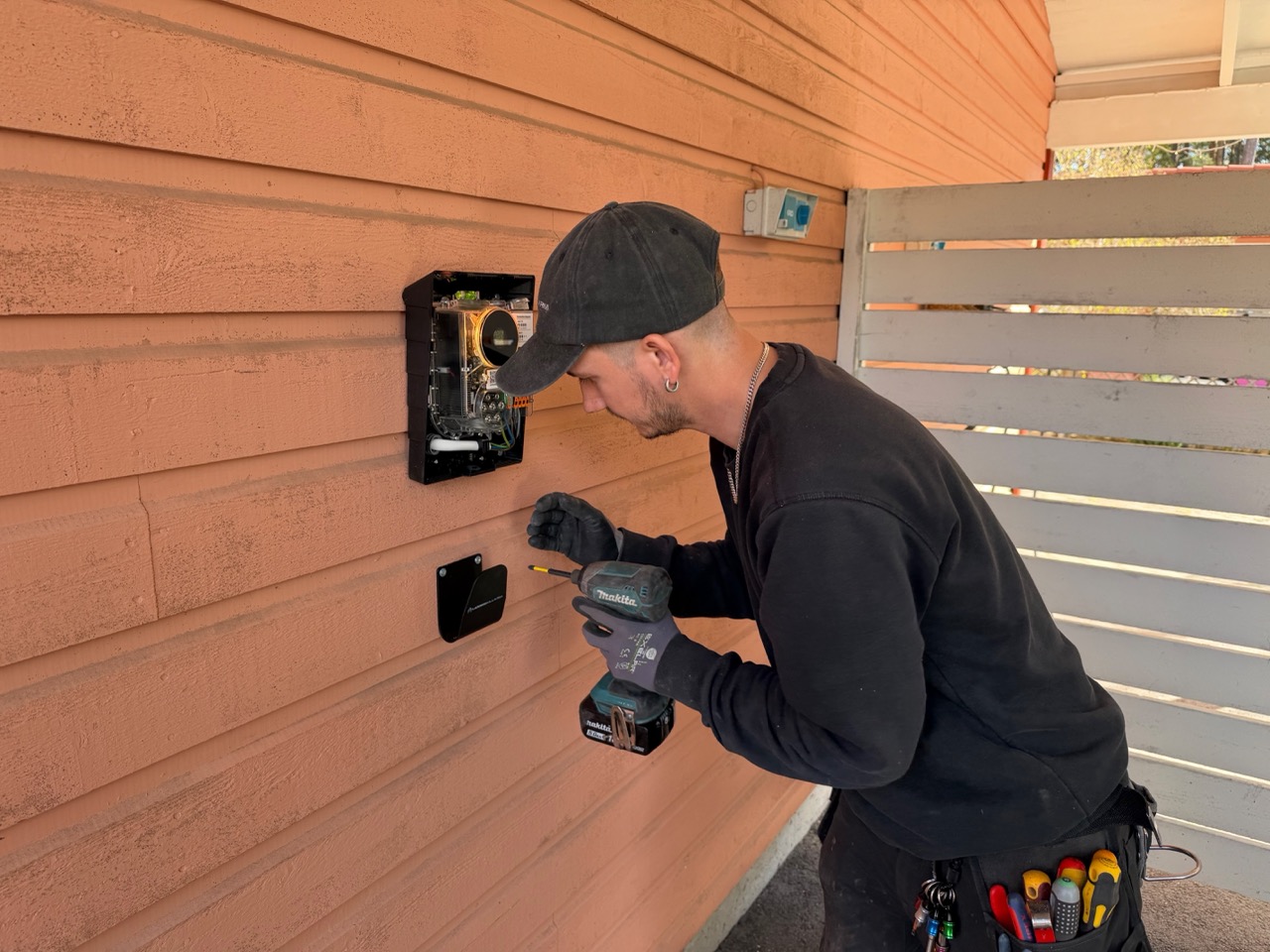 Magnus installing the wall-mounted Perific load balancer enclosure