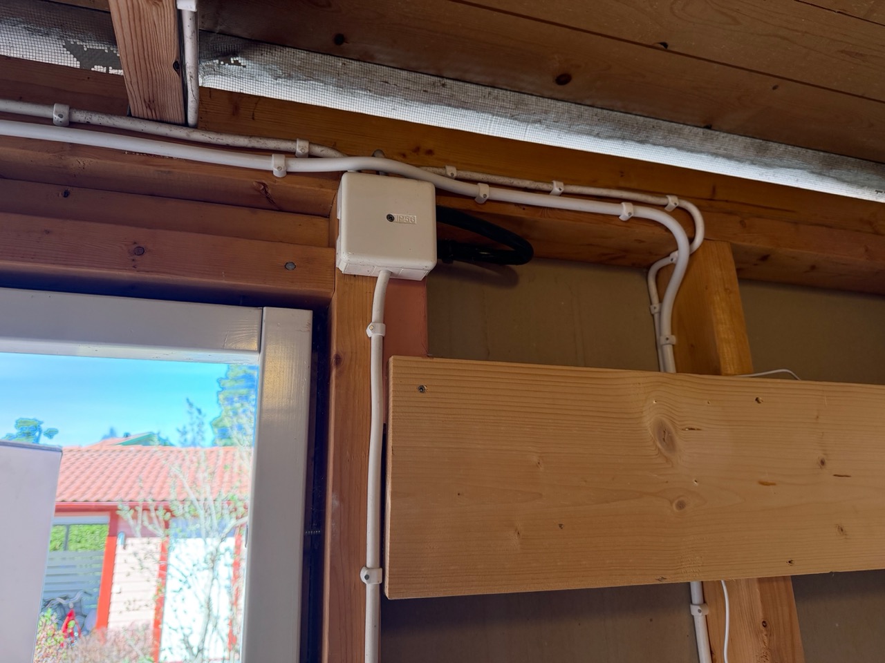 Storage room ceiling with new cable cleanly routed alongside existing junction box
