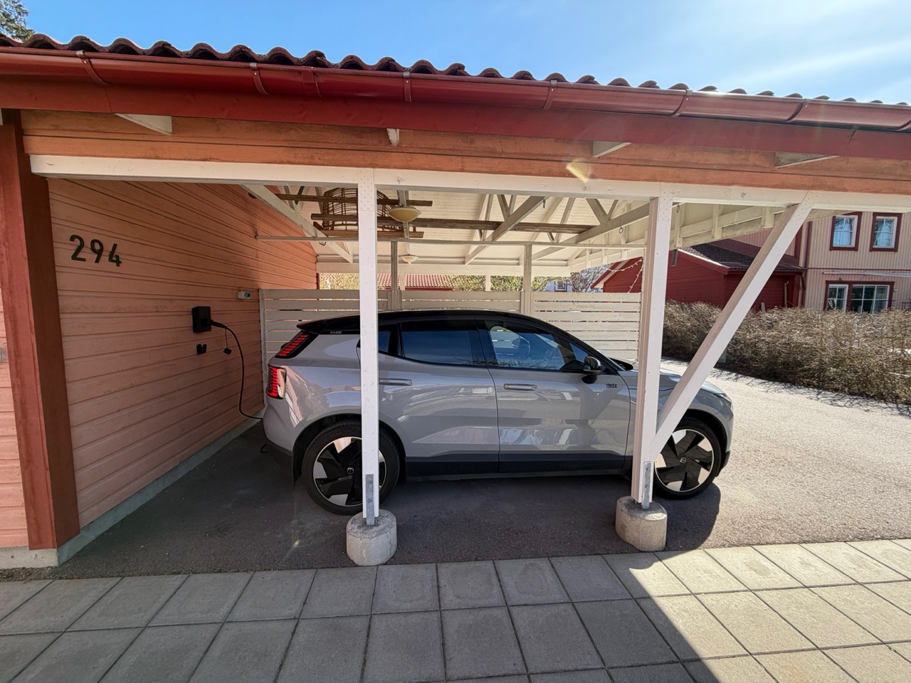 Carport with the Zaptec Go 2 installed on the wall, charger ready, carport empty