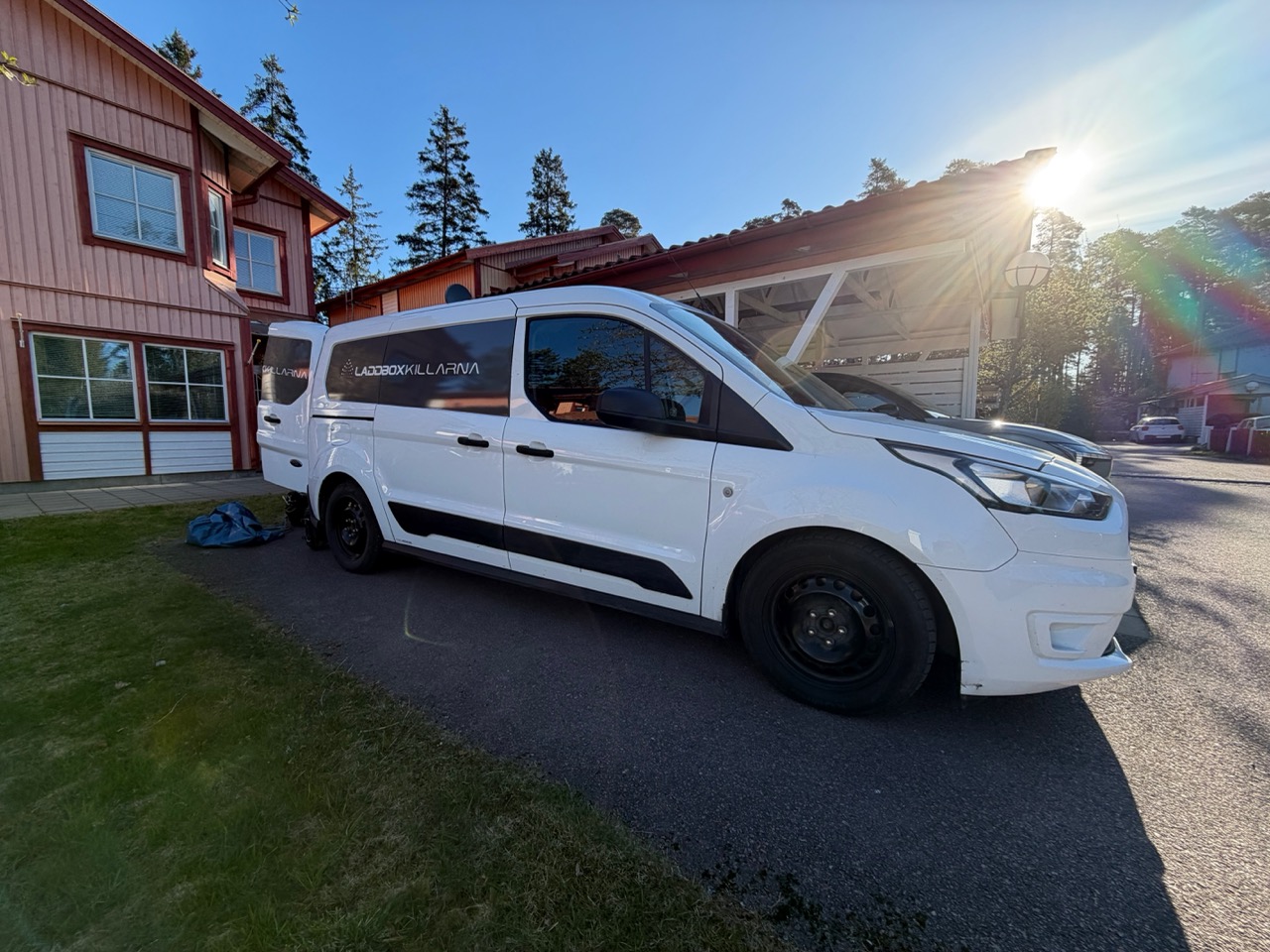 Laddboxkillarna van pulling into the driveway in morning light