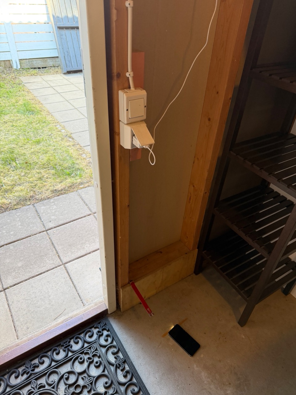 Storage room interior showing existing white wall socket near the door