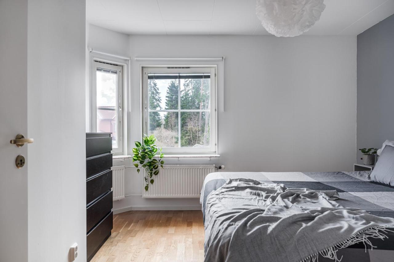 Cozy bedroom with window overlooking forest in Uppsala short term rental
